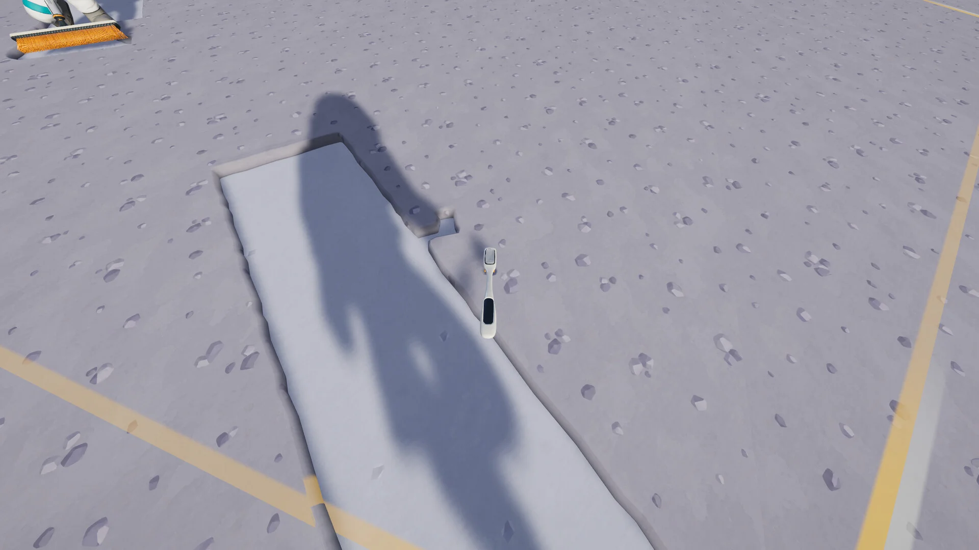 A toothbrush rests beside a cleaned strip in the lunar dust.