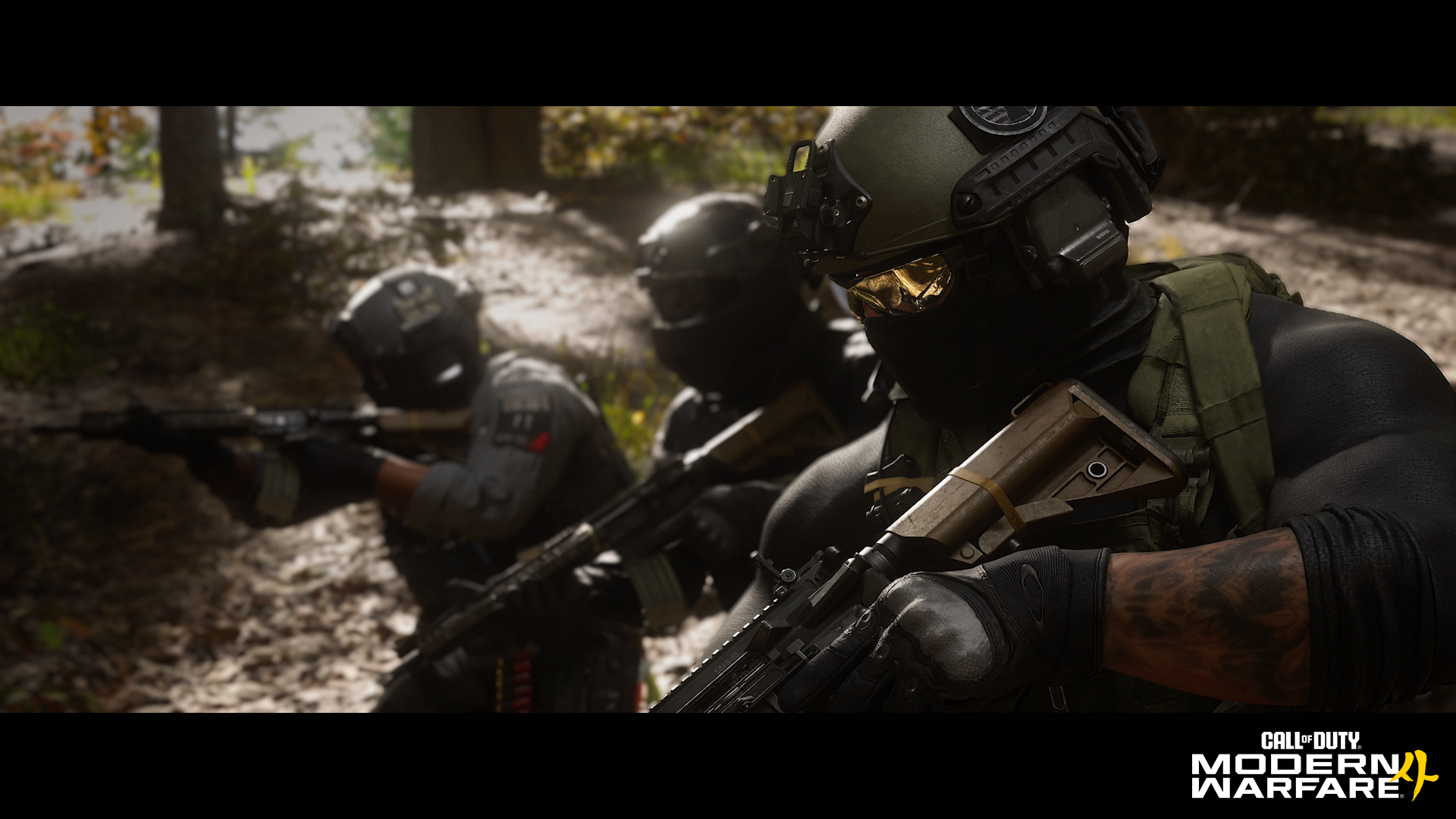 Three armed MW4 soldiers in tactical equipment advance through a wooded area.