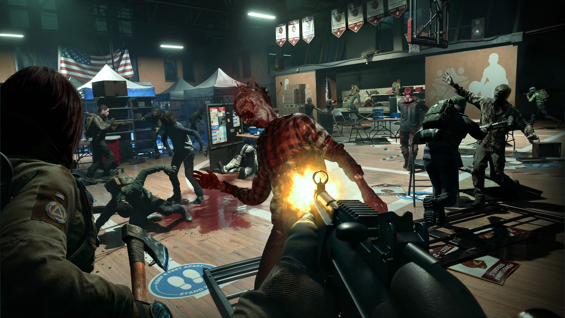 No More Room in Hell 2 survivors fighting a dense zombie horde inside a gym